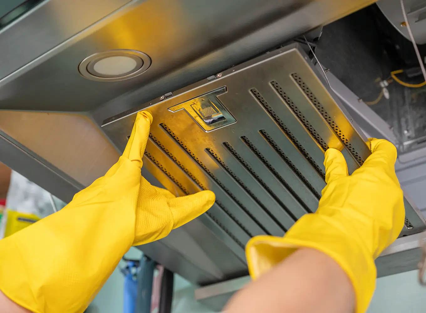 Handyman performing kitchen cooking hood maintenance services in collinsville il