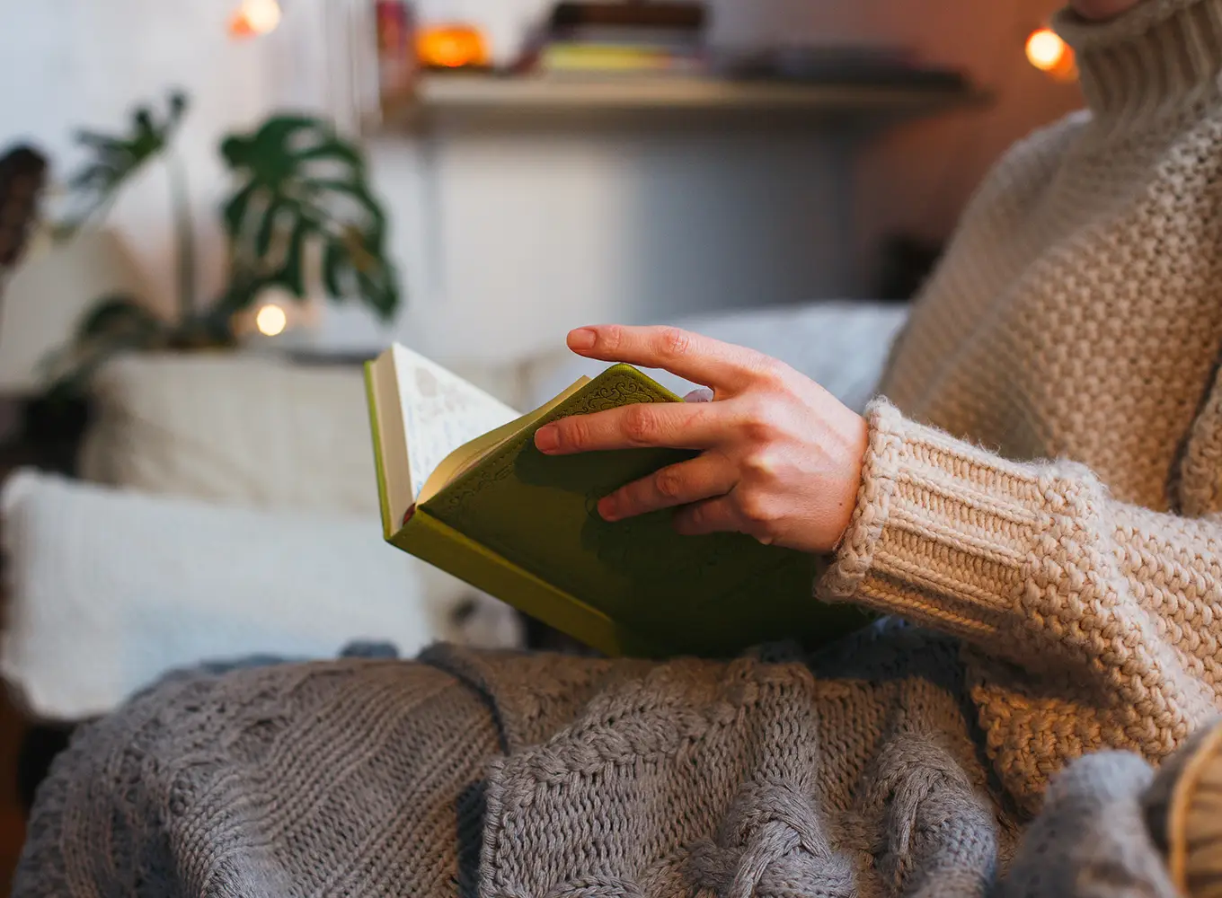 woman reading a book in her cozy home with a working heating system