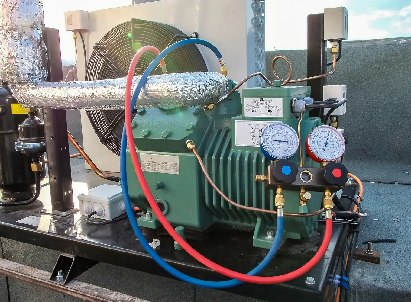 Close-up shot of a commercial refrigeration system showing detailed components and gauges.